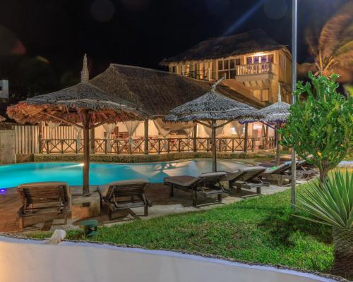 a resort with a swimming pool with umbrellas at Mawe Zuri Resort in Watamu