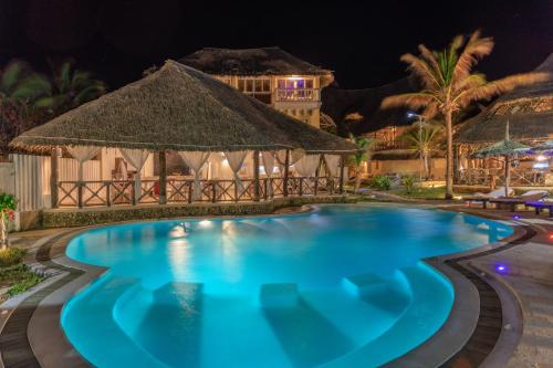 a swimming pool at night at a resort at Mawe Zuri Resort in Watamu