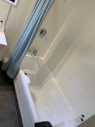 a bathroom with a bath tub with a sink at 755 Regal Court Motel in Dunedin