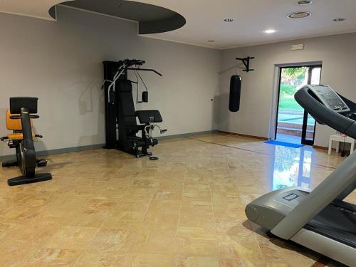 a gym with treadmills and machines in a room at Resort Sciabache in Zambrone