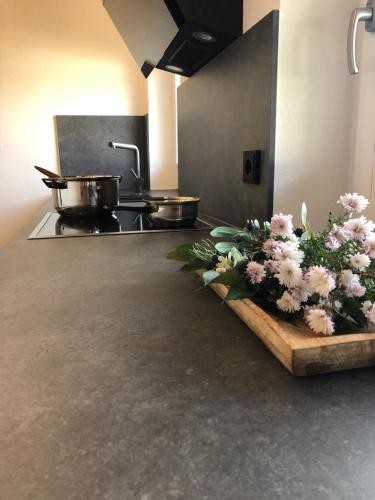 a kitchen with a counter with flowers on it at Ferienwohnung Familie Zint in Sonthofen