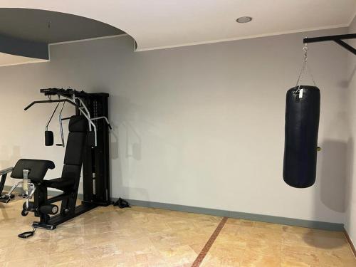 a gym with a punching bag hanging from a wall at Resort Sciabache in Zambrone