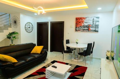 a living room with a couch and a table at Cc & Cg Homes Luxury 4-Beds Apart Abuja-24Hrs Power in Abuja