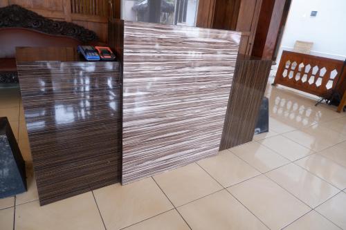 a sliding door in a room with a tile floor at Griya Limasan Gunung Kidul in Wonosari