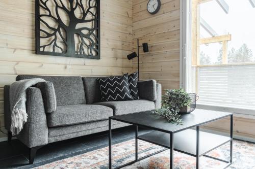 een woonkamer met een bank en een tafel bij Holiday in Lapland - Levihovi 6C in Levi