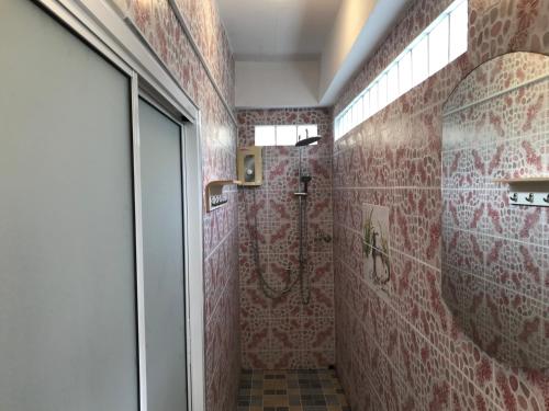 a bathroom with a shower with red tile at Apartment kata in Kata Beach
