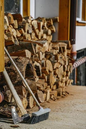 a pile of wood leaned up against a wall with a broom at AMAZING view, privacy and comfort - SPA Villa Krasi in Blagoevgrad
