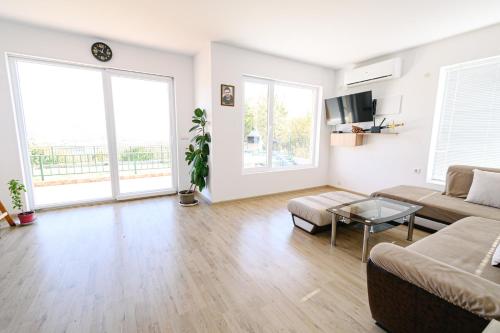 a living room with a couch and a table at AMAZING view, privacy and comfort - SPA Villa Krasi in Blagoevgrad