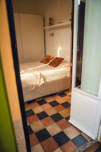 a bedroom with a bed and a checkered floor at Casa N in Arona