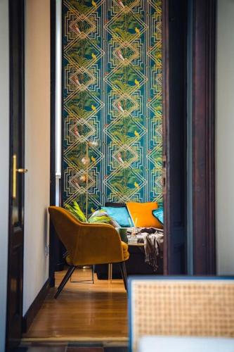 a room with a chair and a wall at Casa N in Arona