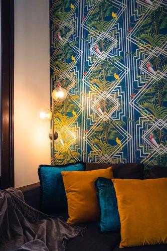 a living room with a couch with a colorful wall at Casa N in Arona