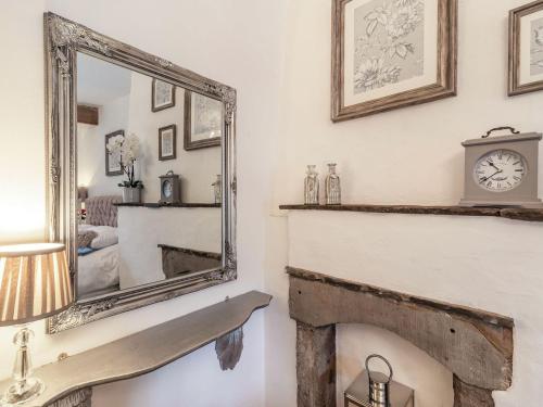 a mirror over a fireplace in a living room at Tynedale in Padiham