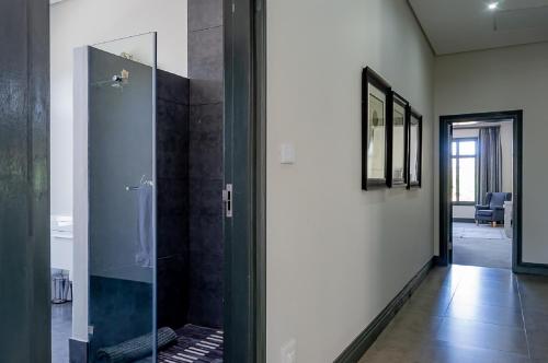 a glass shower in a room with a hallway at House 217 in Nottingham Road