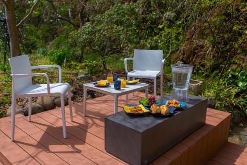 two chairs and a table on a patio at Suite Villa Kamakura Jomyoji in Kamakura