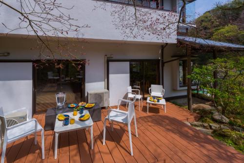 a patio with a table and chairs on a deck at Suite Villa Kamakura Jomyoji in Kamakura