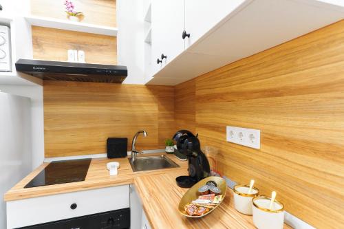 a small kitchen with a sink and a counter top at Bella House Apartaments in Craiova