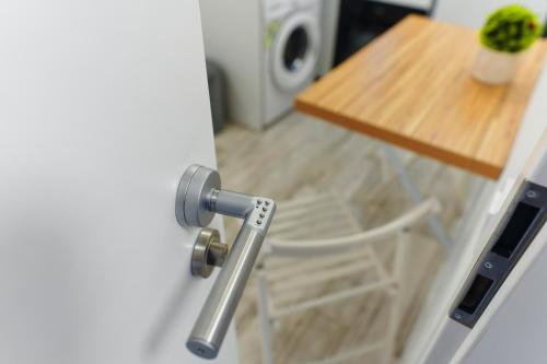 a door with a door knob and a chair in a kitchen at Bella House Apartaments in Craiova