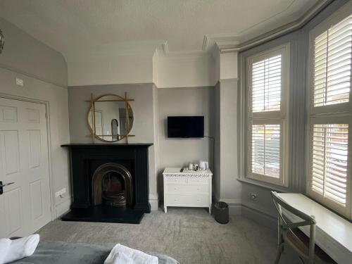 a living room with a fireplace and a mirror at Grange Lodge in York