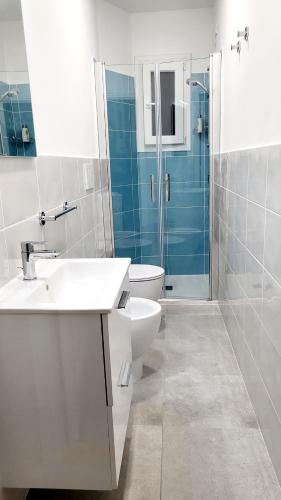 a bathroom with a sink and a toilet and a shower at Central Rooms Best Vacation Ever in Cagliari
