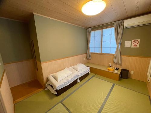Postel nebo postele na pokoji v ubytování GuestHouse Guu