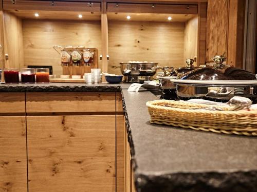 a kitchen with a counter top with a sink and a counter sidx sidx at Hotel Die Krone - Immenstadt-Stein in Immenstadt im Allgäu