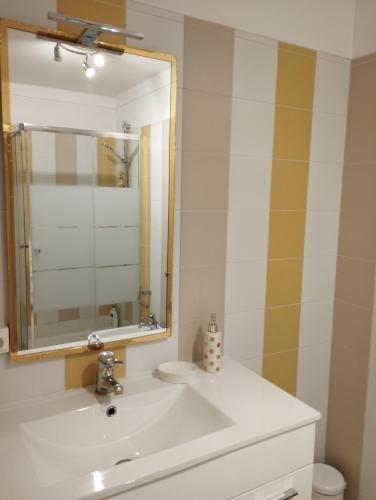 a bathroom with a sink and a mirror and a toilet at Alameda Residence in Tomar