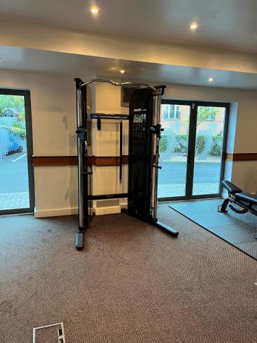 a room with a gym with a treadmill and a room with windows at Legacy Preston International Hotel in Preston
