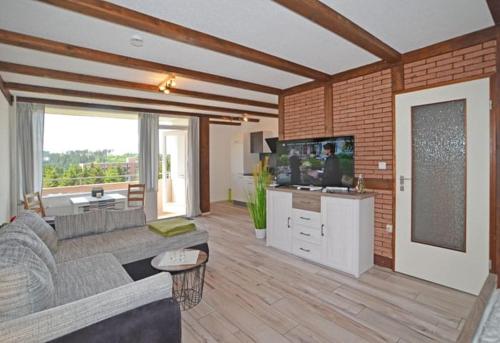 a living room with a couch and a tv at FeWo Harzstube Die romantische Stube für Zwei! in Altenau