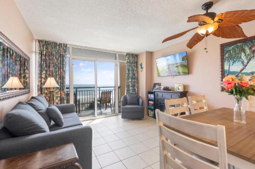 a living room and dining room with a table and a couch at Atlantica Towers Condo w Balcony by Hosteeva in Myrtle Beach