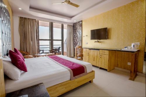 a bedroom with a large bed and a television at The Alpine Resort in Lansdowne