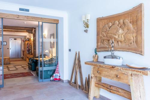 a room with a table with a carving on the wall at Residence Prapoz in Ortisei