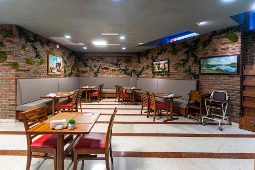 a restaurant with tables and chairs and a brick wall at Aprilis Hotel - Special Category in Istanbul
