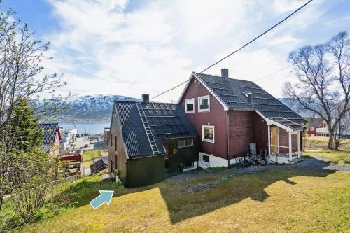 a house with solar panels on top of it at Cozy little house in Tromsø city in Tromsø