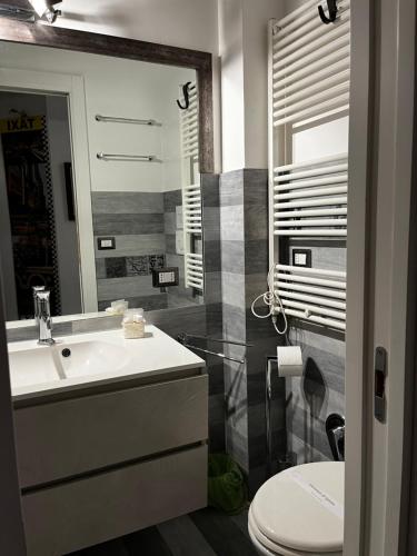 a bathroom with a sink and a toilet at Casa Giorgia luxury apartment in Rome