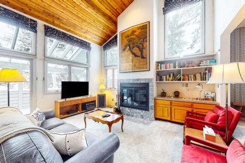 a living room with a couch and a fireplace at Stone Creek Lodge in Avon