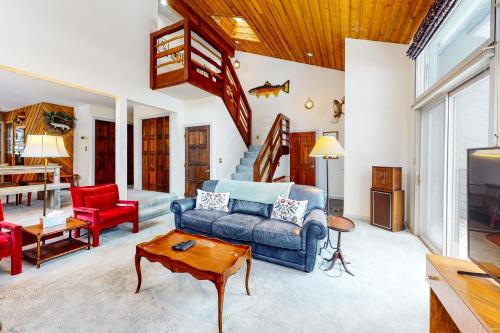 a living room with a couch and a table at Stone Creek Lodge in Avon