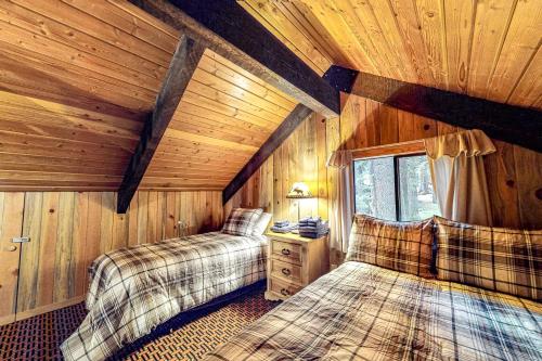 a bedroom with two beds in a wooden cabin at Blue Pine Lodge in Joseph