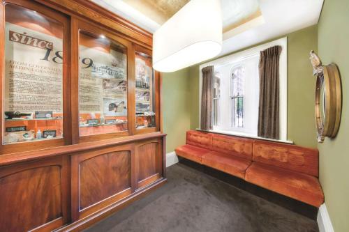 a hallway with a window and a bench in a room at Adina Apartment Hotel Adelaide Treasury in Adelaide