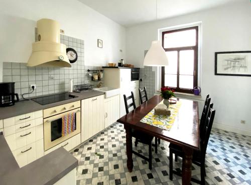 a kitchen with a wooden table and a dining room at Zitronenhaus in Bad Frankenhausen