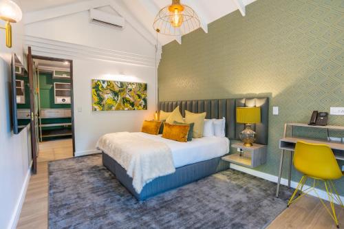 a bedroom with a bed and a yellow chair at Thaba Eco Hotel in Johannesburg
