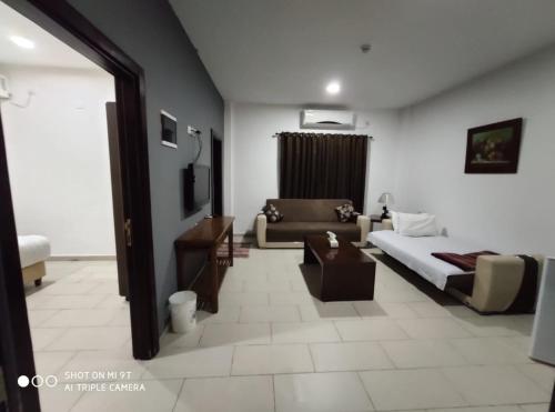 a living room with a bed and a couch at Bab Al Shams Resort in Jericho