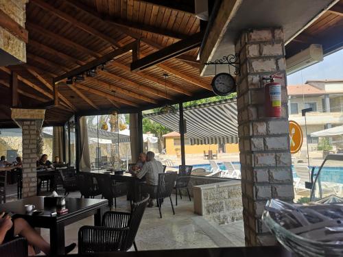 a restaurant with tables and chairs and a pool at Bab Al Shams Resort in Jericho