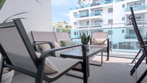 a patio with chairs and a table on a balcony at Dunas Beach II Apartment in Torrox Costa