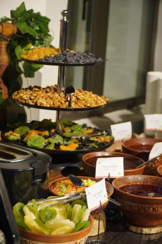 a buffet with different plates of food on a table at Ivy Garden Hotel Baku in Baku