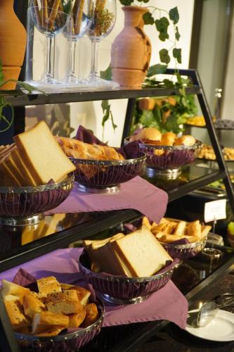 a buffet with various types of bread and pies at Ivy Garden Hotel Baku in Baku