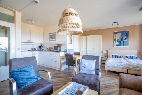 a living room with a couch and a table at Appartementencomplex Juliana 158 in De Koog