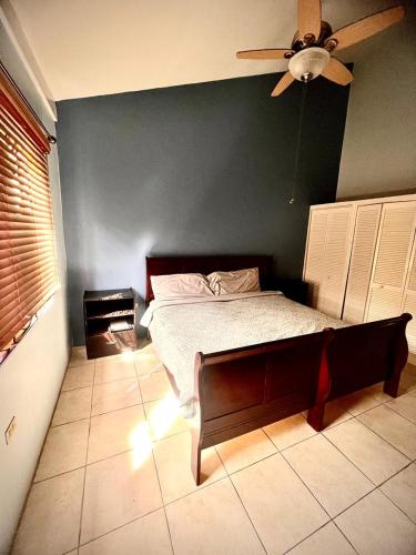a bedroom with a bed and a ceiling fan at Oasis Realm in Kingston