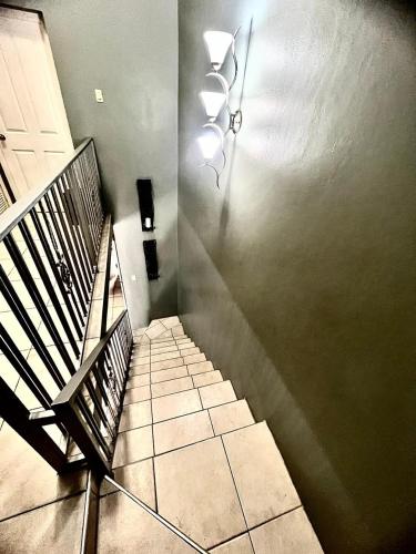 a hallway with a staircase with a bench and a light at Oasis Realm in Kingston