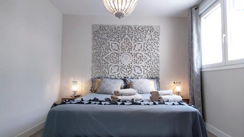 a bedroom with a blue bed with towels on it at Dunas Beach II Apartment in Torrox Costa