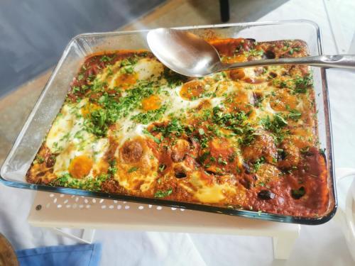 a casserole dish of food with a spoon in it at Bab Al Shams Resort in Jericho